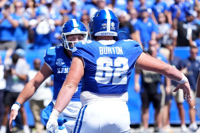 Kentuckyâ€™s quarterback Zach Calzada (5) celebrates with teammate Jager Burton (62) scoring a touchdown against Toledo Saturday afternoon at Kroger Field.
August 30, 2025