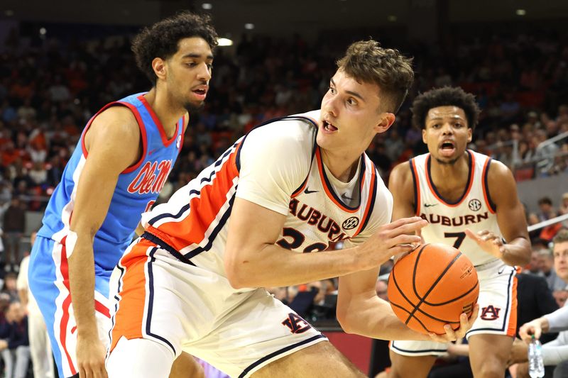 Feb 28, 2026; Auburn, Alabama, USA; Auburn Tigers forward Filip Jovic (38) controls a rebound during the second half against the Mississippi Rebels at Neville Arena. Mandatory Credit: John Reed-Imagn Images