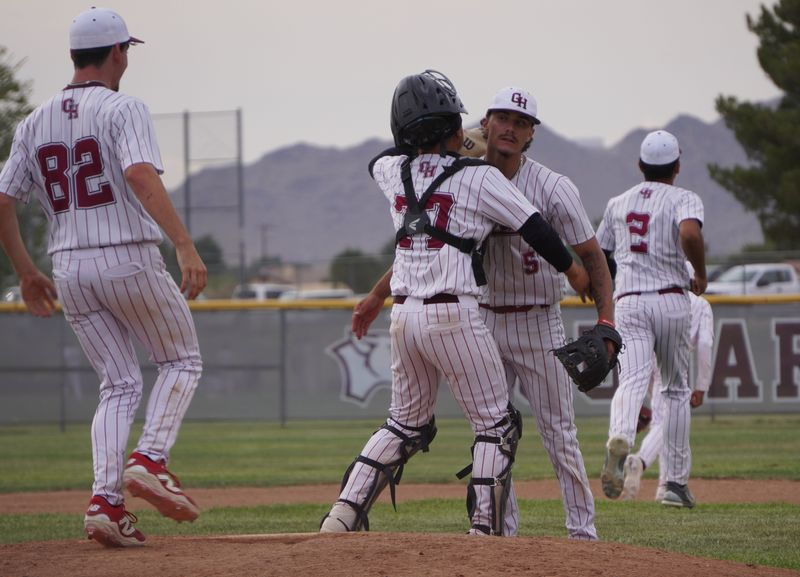 Granite Hills starting pitcher Vincent Jarvis, center, is met by catcher Jordan Proctor after beating Adelanto on Thursday, April 9, 2026. Granite Hills beat Adelanto 5-4 and took over first place in the Desert Sky League standings.