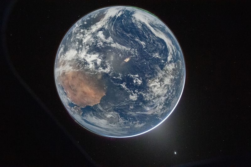 Artemis II Commander Reid Wiseman of NASA took this stunning photograph of Earth from the Orion spacecraft's window on April 2. The image is reminiscent of the iconic "blue marble" image captured during the Apollo 17 mission in 1972.