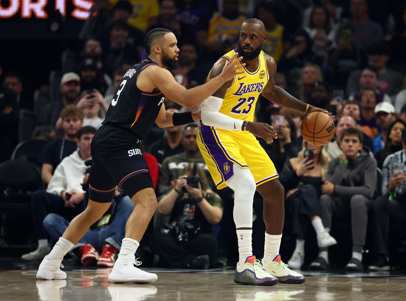 Dec 23, 2025; Phoenix, Arizona, USA; Phoenix Suns forward Dillon Brooks (3) defends against Los Angeles Lakers forward LeBron James (23) in the first half at Mortgage Matchup Center. Mandatory Credit: Mark J. Rebilas-Imagn Images