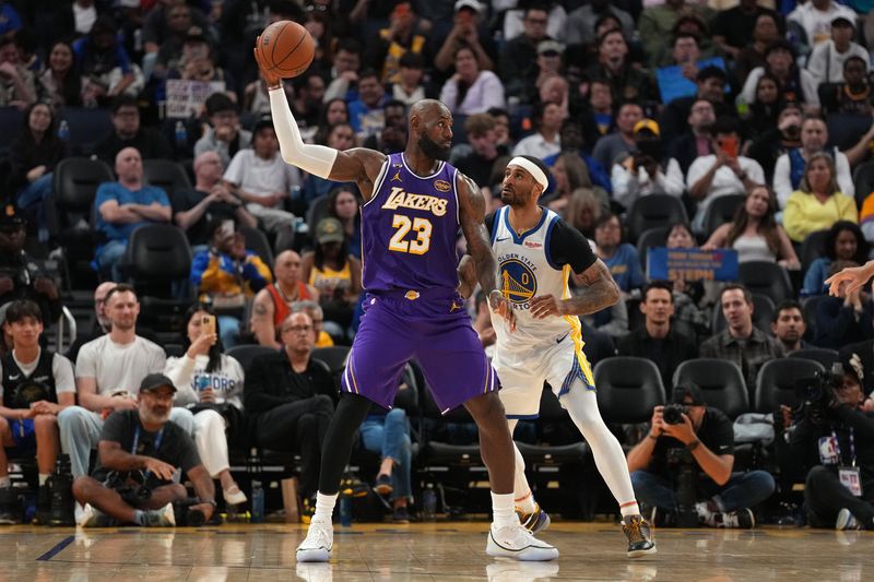 Apr 9, 2026; San Francisco, California, USA; Los Angeles Lakers forward LeBron James (23) holds onto the ball next to Golden State Warriors guard Gary Payton II (0) in the third quarter at the Chase Center. Mandatory Credit: Cary Edmondson-Imagn Images