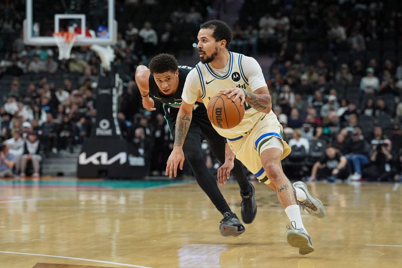 Jan 15, 2026; San Antonio, Texas, USA; Milwaukee Bucks guard Cole Anthony (50) dribbles past San Antonio Spurs forward Carter Bryant (11) in the second half at Frost Bank Center. Mandatory Credit: Daniel Dunn-Imagn Images