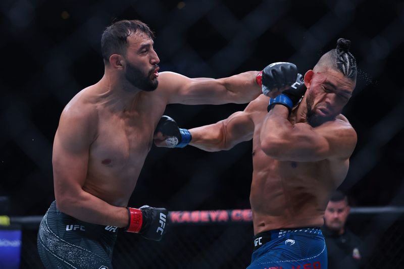 Apr 11, 2026; Miami, Florida, UNITED STATES; Dominick Reyes (red gloves) fights Johnny Walker (blue gloves) during UFC 327 at Kaseya Center. Mandatory Credit: Sam Navarro-Imagn Images