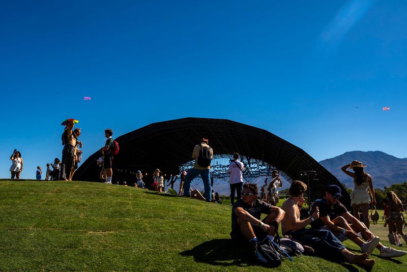 Festivalgoers hang out in the grass on top of the Radiohead bunker early in the day during Weekend 1 of the Coachella Valley Music and Arts Festival in Indio, Calif., Saturday, April 11, 2026.