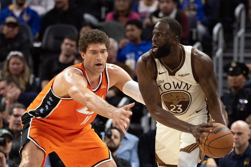 Mar 2, 2026; San Francisco, California, USA; Golden State Warriors forward Draymond Green (23) looks to pass around Los Angeles Clippers center Brook Lopez (11) during the third quarter at Chase Center. Mandatory Credit: D. Ross Cameron-Imagn Images