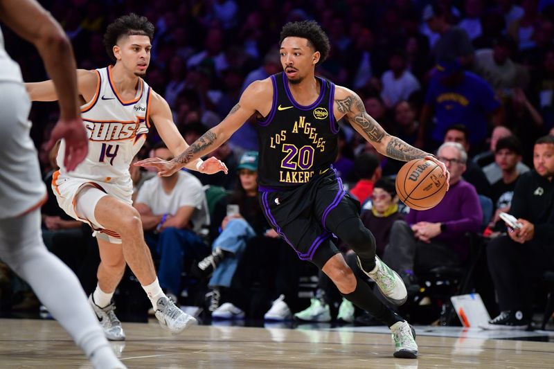 Apr 10, 2026; Los Angeles, California, USA; Los Angeles Lakers guard Nick Smith Jr. (20) moves the ball against Phoenix Suns guard Koby Brea (14) during the second half at Crypto.com Arena. Mandatory Credit: Gary A. Vasquez-Imagn Images