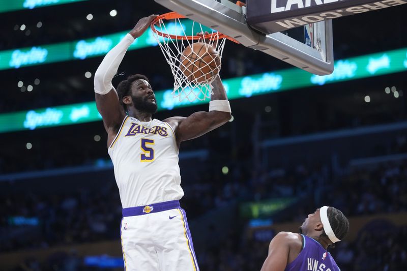 Apr 12, 2026; Los Angeles, California, USA; Los Angeles Lakers center Deandre Ayton (5) dunks the ball against the Utah Jazz in the first half at Crypto.com Arena. Mandatory Credit: Kirby Lee-Imagn Images