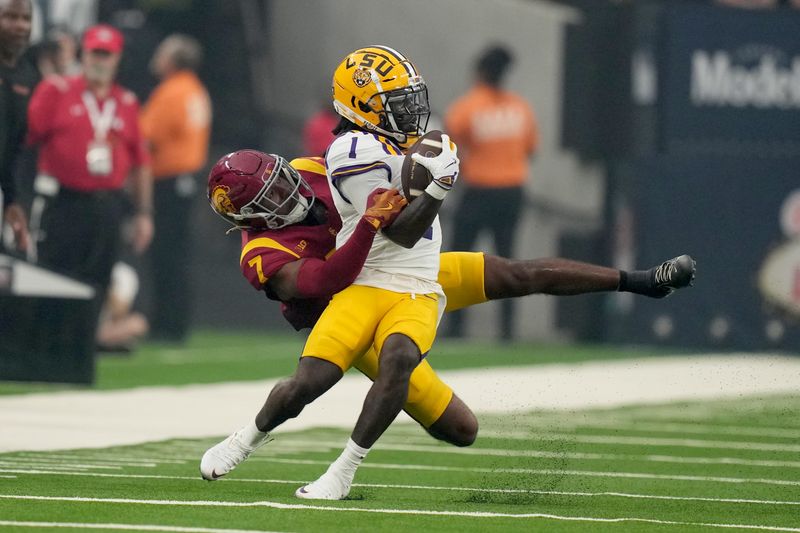 Sep 1, 2024; Paradise, Nevada, USA; LSU Tigers wide receiver Aaron Anderson (1) is tackled by Southern California Trojans safety Kamari Ramsey (7) in the first half at Allegiant Stadium. Mandatory Credit: Kirby Lee-USA TODAY Sports