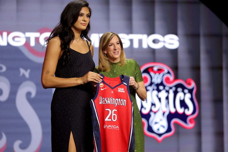 WNBA Commissioner Cathy Engelbert (left) poses for photos with Lauren Betts who was selected fourth overall by the Washington Mystics.