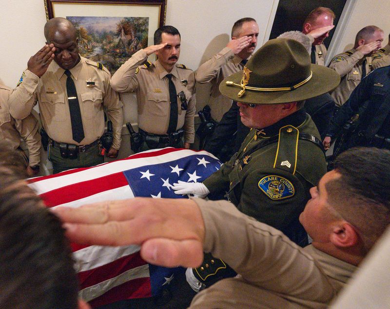 Tulare County Deputies line the hall Monday, April 13, 2026 at Salser & Dillard Funeral Chapel for the transfer of Tulare County Deputy Randy Hoppert. The deputy was killed in the line of duty last week.