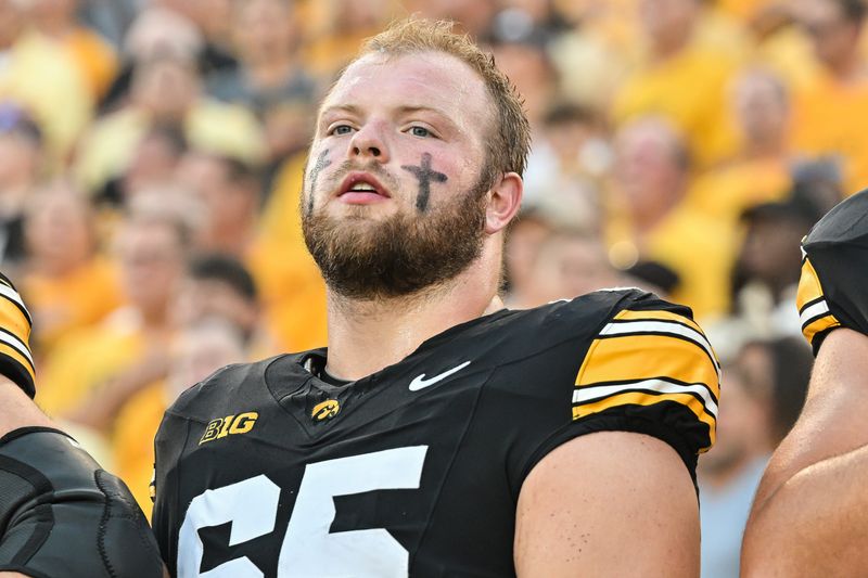 Sep 13, 2025; Iowa City, Iowa, USA; Iowa Hawkeyes offensive lineman Logan Jones (65) looks on before the game against the Massachusetts Minutemen at Kinnick Stadium. Mandatory Credit: Jeffrey Becker-Imagn Images
