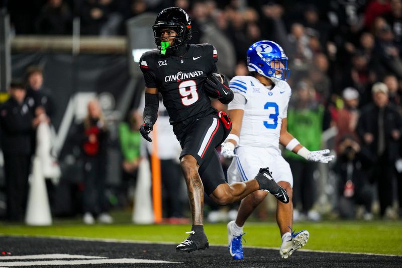 Nov 22, 2025; Cincinnati, Ohio, USA; Cincinnati Bearcats wide receiver Jeff Caldwell (9) catches a pass for a touchdown against the BYU Cougars in the second half at Nippert Stadium. Mandatory Credit: Aaron Doster-Imagn Images
