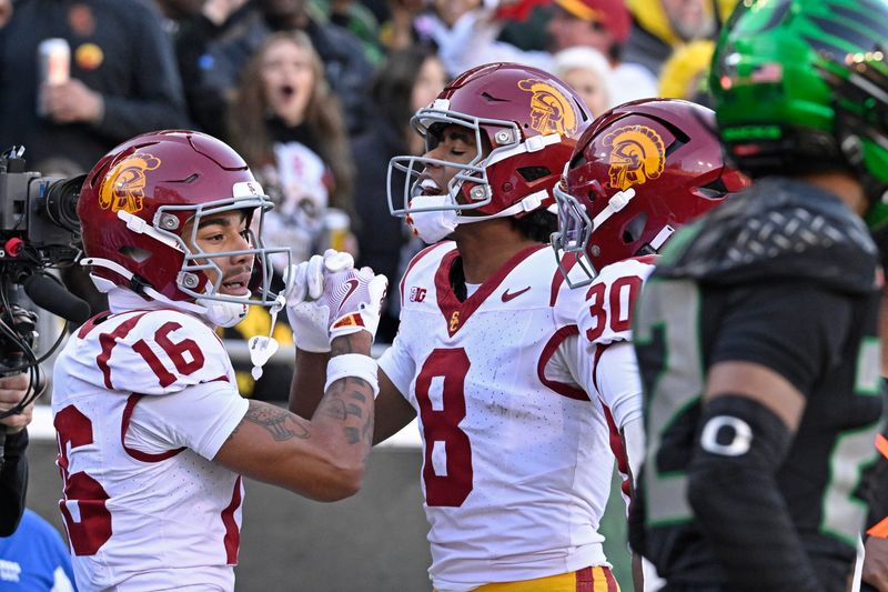 Nov 22, 2025; Eugene, Oregon, USA; Southern California Trojans wide receiver Tanook Hines (16) celebrates scoring a touch down with wide receiver Ja'Kobi Lane (8) during the first half at Autzen Stadium. Mandatory Credit: Troy Wayrynen-Imagn Images