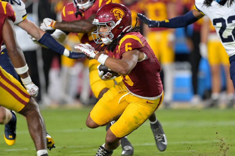 Oct 11, 2025; Los Angeles, California, USA; USC Trojans wide receiver Makai Lemon (6) takes the ball on a kickoff return in the second half against the Michigan Wolverines at United Airlines Field at the Los Angeles Memorial Coliseum. Mandatory Credit: Jayne Kamin-Oncea-Imagn Images