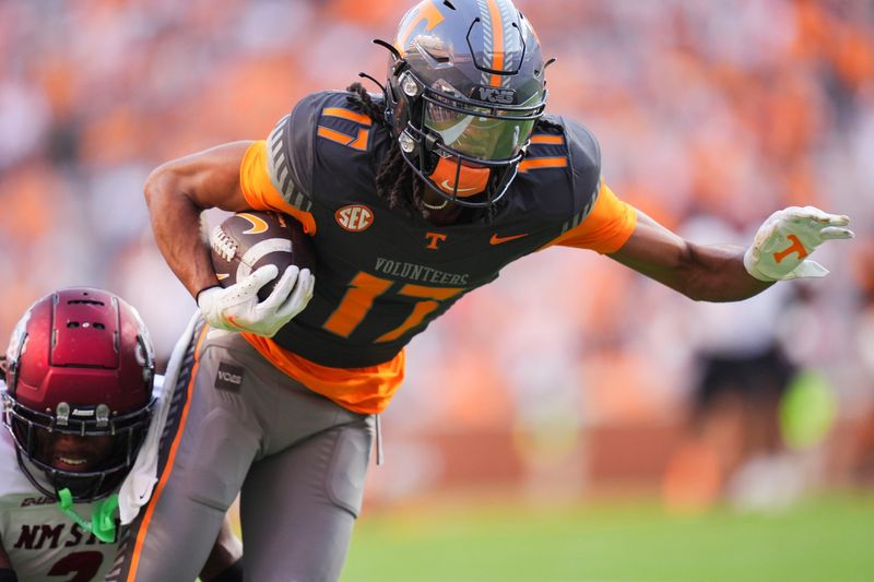 Tennessee wide receiver Chris Brazzell II (17) moves the ball while grabbed by New Mexico State safety Armahn Hale (2) during an NCAA college football game on November 15, 2025, in Knoxville, Tenn.