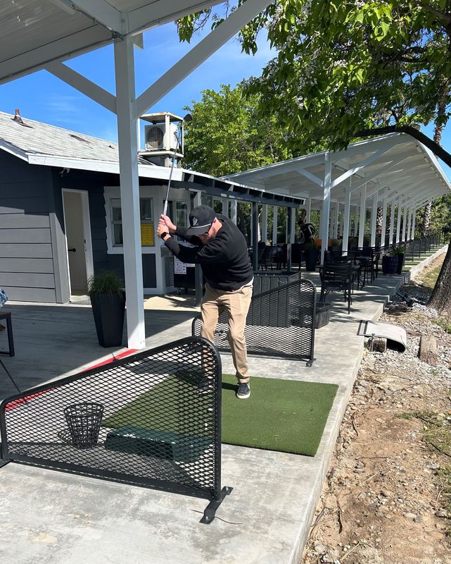 Matt Briner hits a ball at the new Aqua Golf on Friday, April 17, 2026.