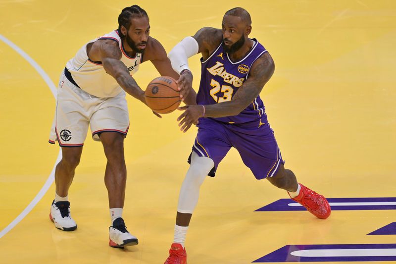 Nov 25, 2025; Los Angeles, California, USA; Los Angeles Clippers forward Kawhi Leonard (2) defends a pass by Los Angeles Lakers forward LeBron James (23) in the second half at Crypto.com Arena. Mandatory Credit: Jayne Kamin-Oncea-Imagn Images