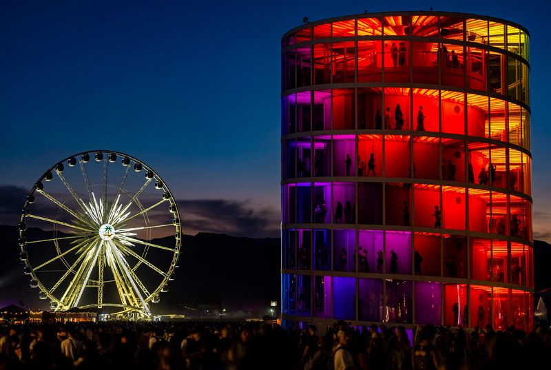 "Spectra" by NEWSUBSTANCE and the Ferris wheel are seen amongst a crowd of festivalgoers during Weekend 2 of the Coachella Valley Music and Arts Festival in Indio, Calif., Saturday, April 18, 2026.