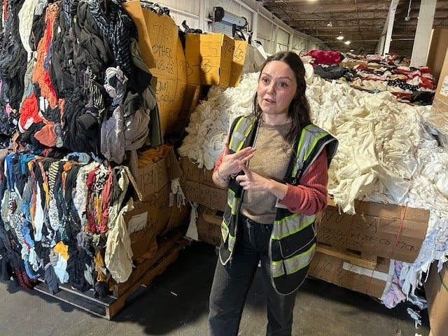Ibby Hartley, Homeboy Threads director of operations, explains to a tour group how un-reusable textiles are turned into “shoddy” stuffing for insulation, mattresses and plush toys.