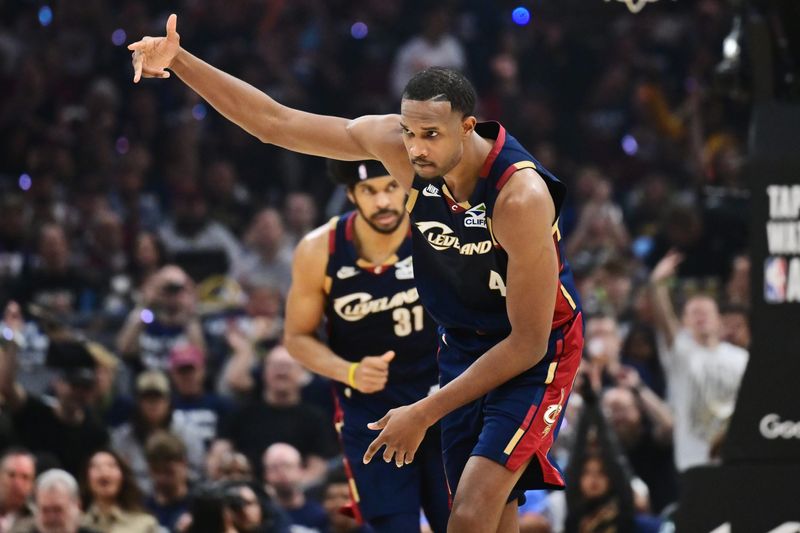 Apr 18, 2026; Cleveland, Ohio, USA; Cleveland Cavaliers center Evan Mobley (4) celebrates after hitting a three point basket against the Toronto Raptors during the second half of game one in the first round of the 2026 NBA Playoffs at Rocket Arena. Mandatory Credit: Ken Blaze-Imagn Images