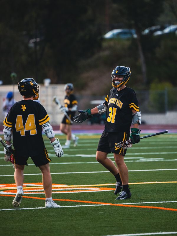 Newbury Park boys lacrosse players Aegean Brown (44) and Tylar Jimenez high-five during the Panthers' 14-13 win over Westlake on April 17, 2026, on the road. It was the Warriors' first league loss since April 8, 2022.