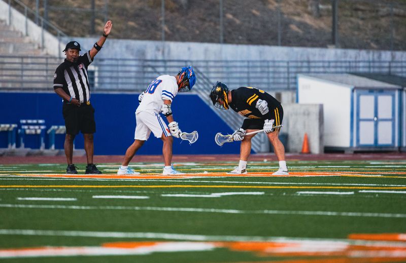 Westlake's Shaylor Schmitt (88) prepares for a faceoff with Newbury Park's Tyler Nowak during a 14-13 Panthers victory on April 17, 2026, at Westlake High. It was the Warriors' first league loss since April 8, 2022.
