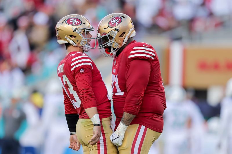 Dec 4, 2022; Santa Clara, California, USA; San Francisco 49ers quarterback Brock Purdy (13) celebrates with offensive tackle Trent Williams (71) after a touchdown during the second quarter at Levi's Stadium. Mandatory Credit: Sergio Estrada-USA TODAY Sports