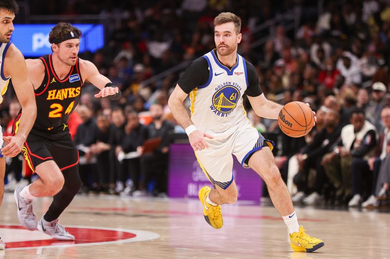Mar 21, 2026; Atlanta, Georgia, USA; Golden State Warriors guard Pat Spencer (61) drives to the basket against the Atlanta Hawks in the fourth quarter at State Farm Arena. Mandatory Credit: Brett Davis-Imagn Images