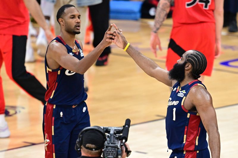 Apr 20, 2026; Cleveland, Ohio, USA; Cleveland Cavaliers center Evan Mobley (4) and guard James Harden (1) celebrates after the Cavaliers defeated the Toronto Raptors in game two of the first round of the 2026 NBA Playoffs at Rocket Arena. Mandatory Credit: David Dermer-Imagn Images