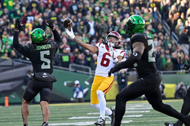 Nov 22, 2025; Eugene, Oregon, USA; Southern California Trojans wide receiver Makai Lemon (6) throws a touch down pass against the Oregon Ducks during the first half at Autzen Stadium. Mandatory Credit: Troy Wayrynen-Imagn Images