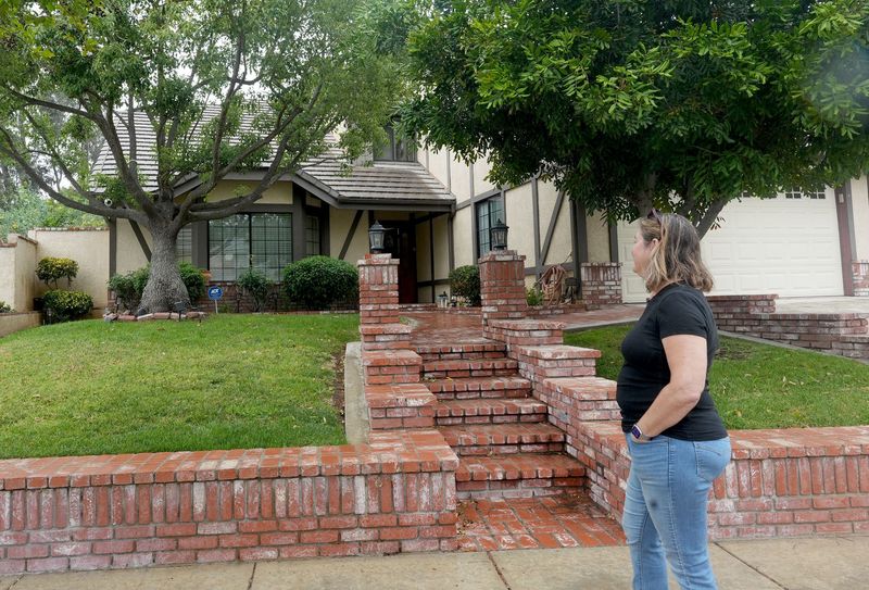 Rachel Powers, owner of the Simi Valley house where some scenes from the movie "Poltergeist" were filmed, stands outside her home on April 21. The city is considering the future of these short-term vacation rentals, and the City Council expected to vote on the issue as early as May 11.