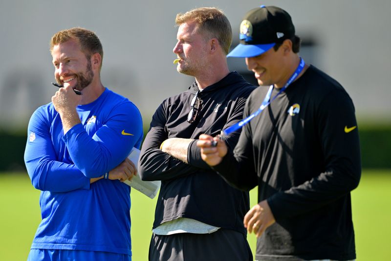 Jul 29, 2024; Los Angeles, CA, USA; Los Angeles Rams head coach Sean McVay, general manager Les Snead and chief of staff Carter Crutchfield talk on the field during training camp at Loyola Marymount University. Mandatory Credit: Jayne Kamin-Oncea-USA TODAY Sports