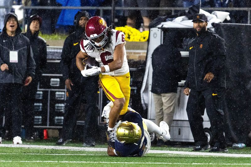 Oct 18, 2025; South Bend, Indiana, USA; Southern California Trojans wide receiver Makai Lemon (6) runs with the ball while Notre Dame Fighting Irish defensive back Devonta Smith (0) defends in the second half at Notre Dame Stadium. Mandatory Credit: Trevor Ruszkowski-Imagn Images