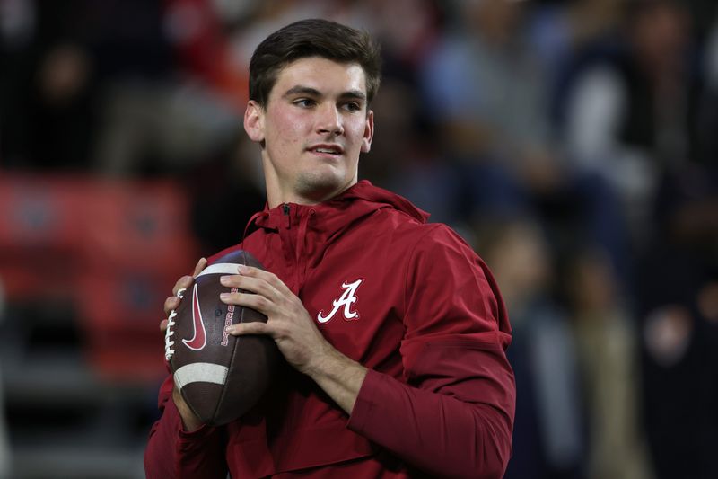 Nov 29, 2025; Auburn, Alabama, USA; Alabama Crimson Tide quarterback Ty Simpson (15) warms up before the game against the Auburn Tigers at Jordan-Hare Stadium. Mandatory Credit: John Reed-Imagn Images