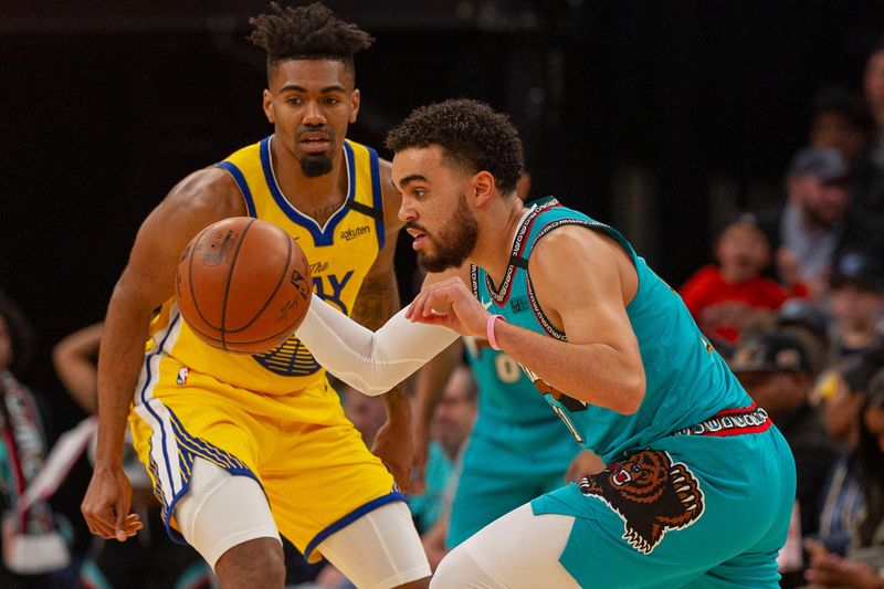 Jan 12, 2020; Memphis, Tennessee, USA; Memphis Grizzlies guard Tyus Jones (21) handles the ball against Golden State Warriors guard Jacob Evans (10) during the first half at FedExForum. Mandatory Credit: Justin Ford-USA TODAY Sports