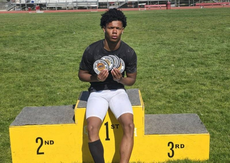 Oak Hills' Quran Clayton Jr. poses with a photo with his patches won at the Mojave River League Finals on April 22, 2026.