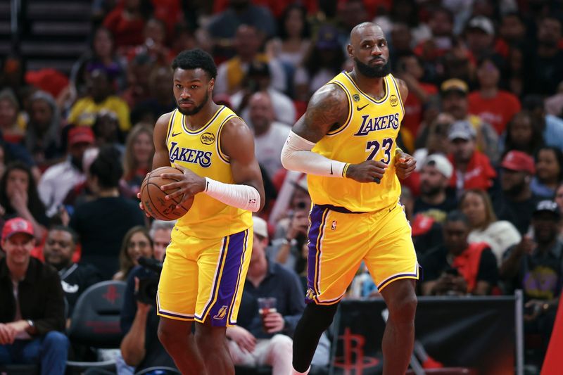 Apr 24, 2026; Houston, Texas, USA; Los Angeles Lakers forward LeBron James (23) gives the ball to guard Bronny James (9) during the fourth quarter against the Houston Rockets during game three of the first round of the 2026 NBA Playoffs at Toyota Center. Mandatory Credit: Troy Taormina-Imagn Images