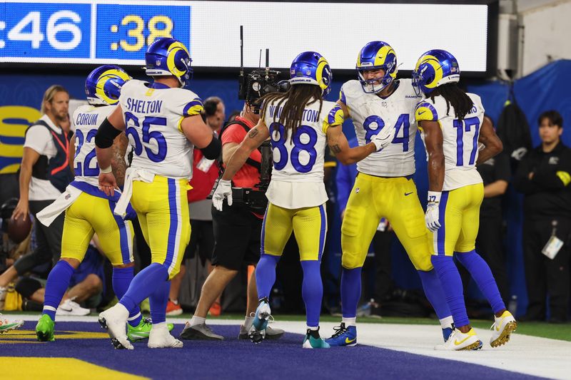 Nov 23, 2025; Inglewood, California, USA; Los Angeles Rams tight end Colby Parkinson (84) celebrates with wide receivers Jordan Whittington (88), Davante Adams (17), center Coleman Shelton (65) and running back Blake Corum (22) after scoring a touchdown against the Tampa Bay Buccaneers during the second quarter at SoFi Stadium. Mandatory Credit: Kiyoshi Mio-Imagn Images