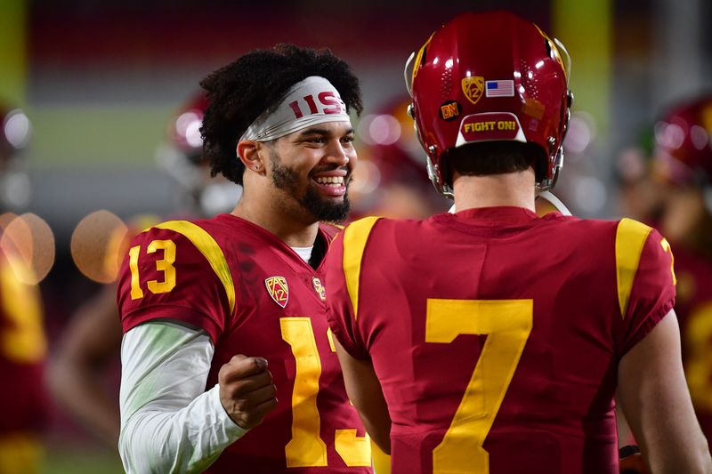 Nov 11, 2022; Los Angeles, California, USA; Southern California Trojans quarterback Caleb Williams (13) speaks with quarterback Miller Moss (7) during the second half at the Los Angeles Memorial Coliseum. Mandatory Credit: Gary A. Vasquez-USA TODAY Sports