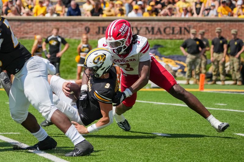 Sep 13, 2025; Columbia, Missouri, USA; Missouri Tigers quarterback Beau Pribula (9) is sacked by Louisiana-Lafayette Ragin Cajuns linebacker Jaden Dugger (3) during the first half of the game at Faurot Field at Memorial Stadium. Mandatory Credit: Denny Medley-Imagn Images