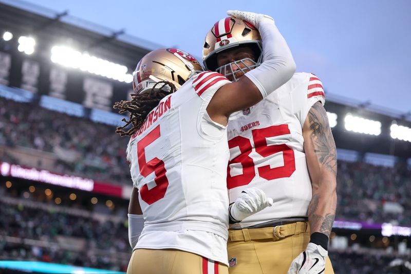 Jan 11, 2026; Philadelphia, PA, USA; San Francisco 49ers wide receiver Demarcus Robinson (5) celebrates a touchdown against the Philadelphia Eagles with tight end George Kittle (85) during the first quarter in an NFC Wild Card Round game at Lincoln Financial Field. Mandatory Credit: Bill Streicher-Imagn Images