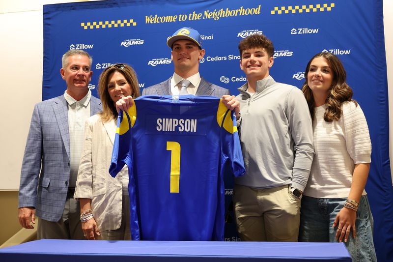 Apr 24, 2026; Inglewood, CA, USA; Los Angeles Rams first-round draft pick Ty Simpson holds his jersey with his family during a press conference at Code Next at Hollywood Park. Mandatory Credit: Kiyoshi Mio-Imagn Images