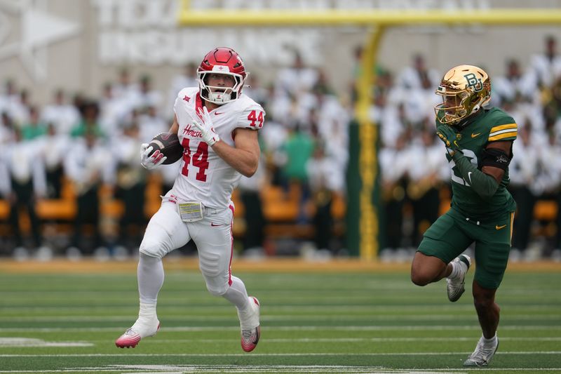 Nov 29, 2025; Waco, Texas, USA; Houston Cougars running back Dean Connors (44) carries the ball ahead of Baylor Bears safety Cameren Jenkins (23) during the second half at McLane Stadium. Mandatory Credit: Chris Jones-Imagn Images