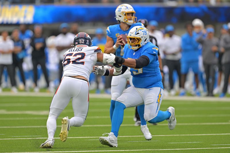 Sep 21, 2025; Inglewood, California, USA; Los Angeles Chargers offensive tackle Trey Pipkins (79) protects quarterback Justin Herbert (10) from Denver Broncos linebacker Jonah Elliss (52) in the first half at SoFi Stadium. Mandatory Credit: Jayne Kamin-Oncea-Imagn Images