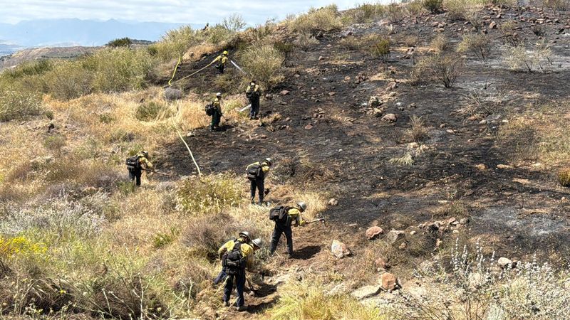 Crews from Ventura County Fire battle a blaze near the Ronald Reagan Presidential Library & Museum in Simi Valley April 27, 2026. Fire officials mapped the blaze at 8.6 acres.