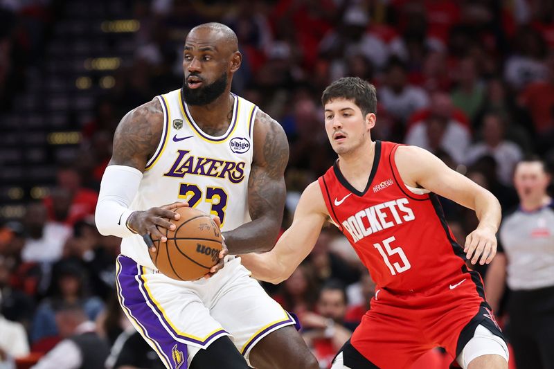 Apr 26, 2026; Houston, Texas, USA; Los Angeles Lakers forward LeBron James (23) controls the ball as Houston Rockets guard Reed Sheppard (15) defends during the first quarter during game four of the first round of the 2026 NBA Playoffs at Toyota Center. Mandatory Credit: Troy Taormina-Imagn Images