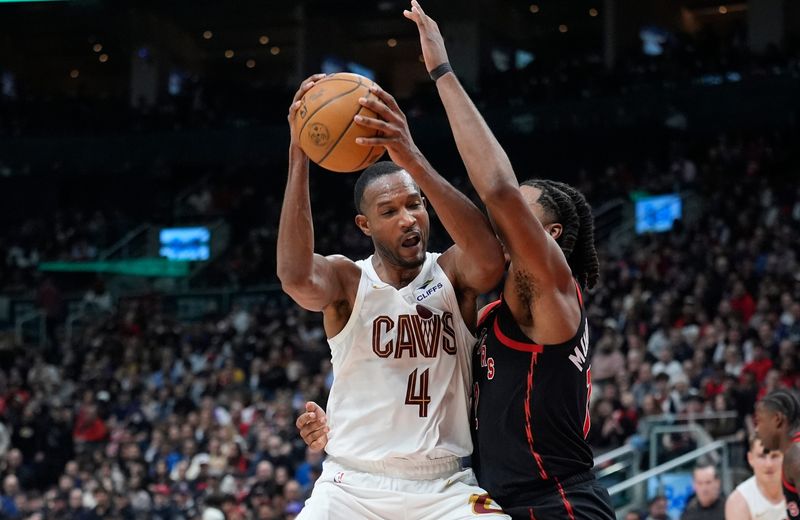 Apr 23, 2026; Toronto, Ontario, CAN; Cleveland Cavaliers forward Evan Mobley (4) battles with Toronto Raptors forward Collin Murray-Boyles (12) during the second half of game three of the first round of the 2026 NBA Playoffs at Scotiabank Arena. Mandatory Credit: John E. Sokolowski-Imagn Images