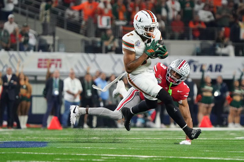 Dec 31, 2025; Arlington, TX, USA; Miami Hurricanes wide receiver CJ Daniels (7) catches while defended by Ohio State Buckeyes cornerback Lorenzo Styles Jr. (3) in the first quarter during the 2025 Cotton Bowl and quarterfinal game of the College Football Playoff at AT&T Stadium. Mandatory Credit: Raymond Carlin III-Imagn Images
