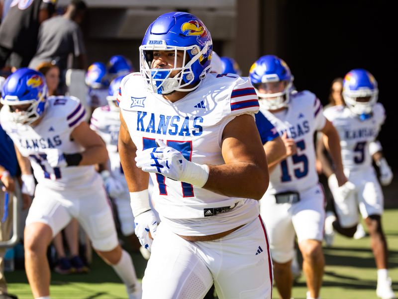 Nov 8, 2025; Tucson, Arizona, USA; Kansas Jayhawks offensive lineman Enrique Cruz Jr. (77) against the Arizona Wildcats at Arizona Stadium. Mandatory Credit: Mark J. Rebilas-Imagn Images